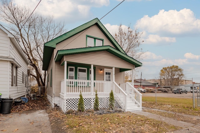 bungalow featuring central AC unit and covered porch