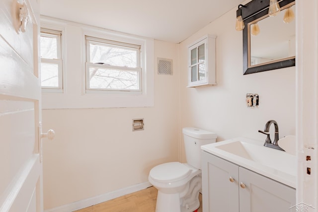 bathroom featuring hardwood / wood-style floors, vanity, and toilet