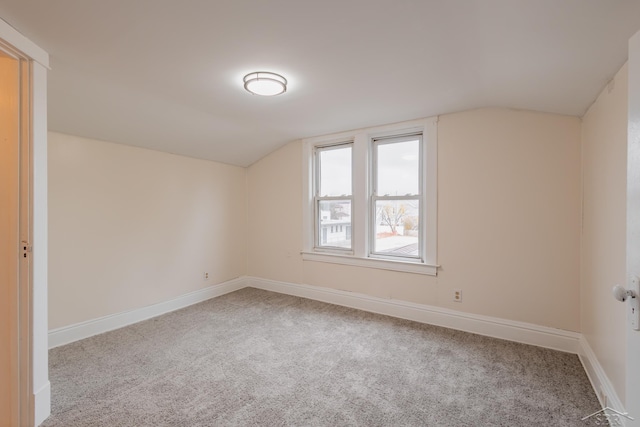 additional living space with carpet floors and vaulted ceiling