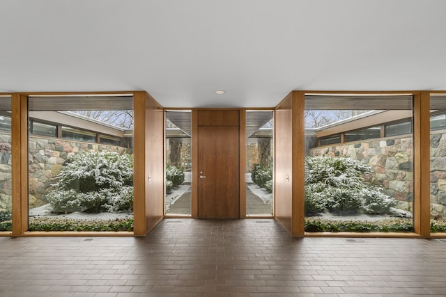 entryway featuring brick floor and recessed lighting