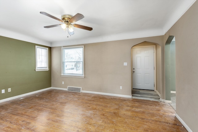 spare room with ceiling fan and wood-type flooring