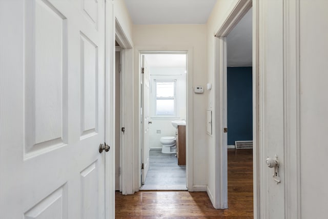 hall with tile walls and dark hardwood / wood-style floors