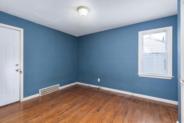 unfurnished room with dark wood-type flooring