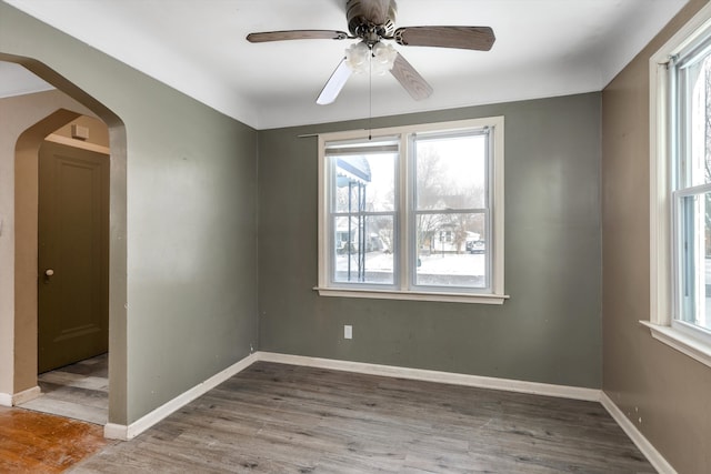 spare room with light wood-type flooring and ceiling fan