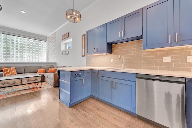 kitchen featuring stainless steel dishwasher, ornamental molding, sink, blue cabinets, and tasteful backsplash