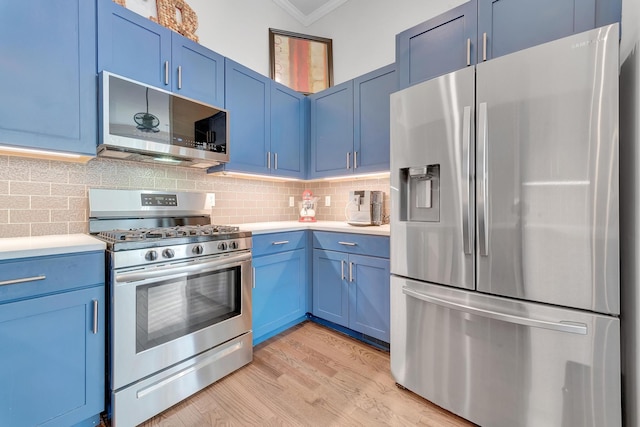 kitchen with light hardwood / wood-style floors, backsplash, blue cabinets, appliances with stainless steel finishes, and ornamental molding