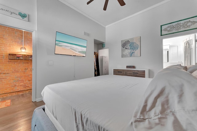 bedroom with crown molding, ceiling fan, and light hardwood / wood-style flooring