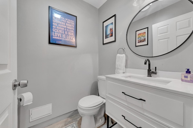 bathroom with tile patterned floors, vanity, and toilet