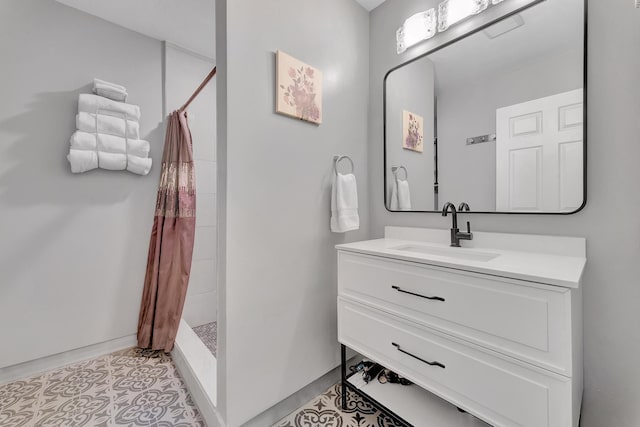 bathroom with a shower with shower curtain, tile patterned flooring, and vanity