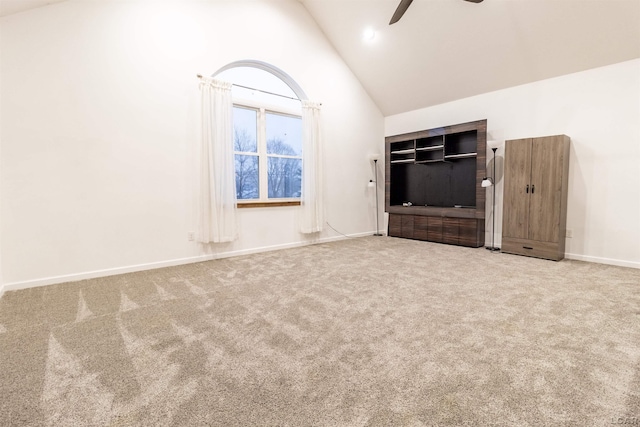 unfurnished living room with carpet flooring, ceiling fan, and high vaulted ceiling