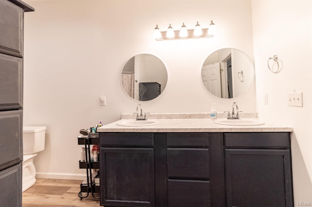 bathroom featuring hardwood / wood-style flooring, vanity, and toilet