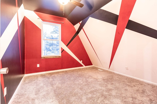 bonus room with carpet flooring, vaulted ceiling, and ceiling fan