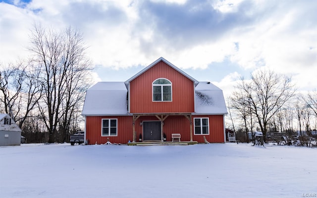 view of snow covered rear of property