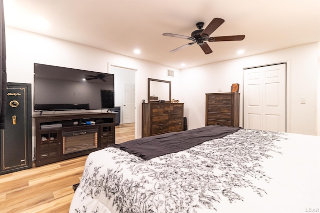 bedroom with light wood-type flooring, a closet, and ceiling fan