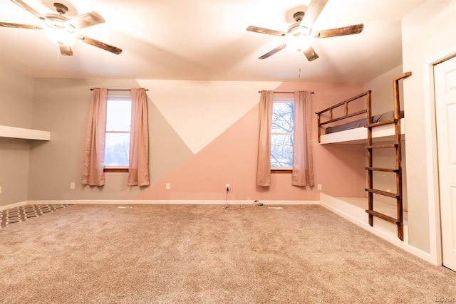 unfurnished room with carpet flooring and ceiling fan