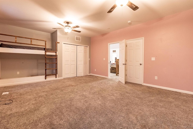 unfurnished bedroom featuring carpet and ceiling fan