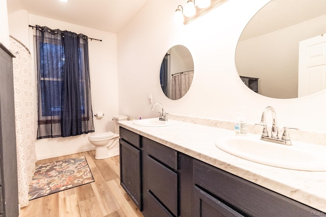 full bathroom featuring shower / tub combo, vanity, hardwood / wood-style flooring, and toilet