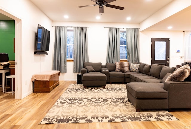 living room featuring hardwood / wood-style flooring, plenty of natural light, and ceiling fan