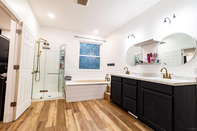 bathroom with wood-type flooring, vanity, and separate shower and tub