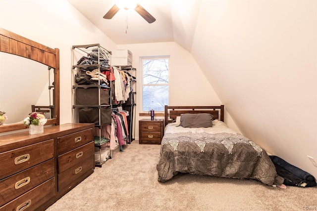 bedroom with ceiling fan, light colored carpet, and lofted ceiling