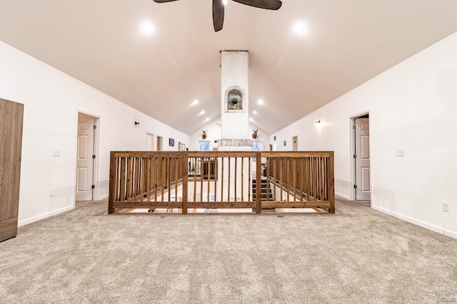 interior space with ceiling fan, carpet, and lofted ceiling