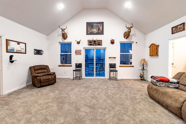 carpeted living room featuring lofted ceiling