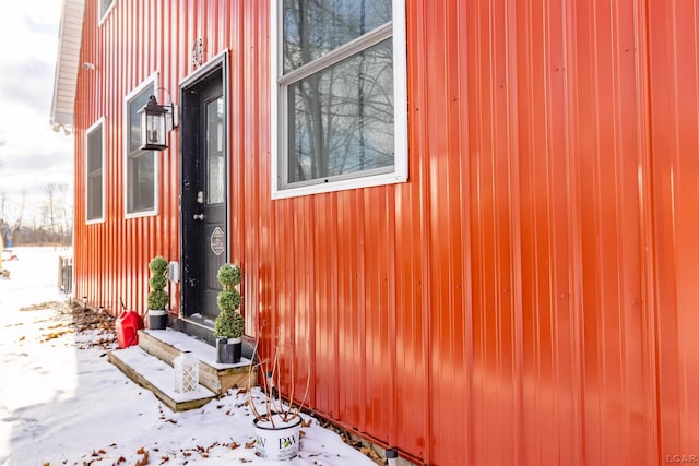 view of snow covered property entrance