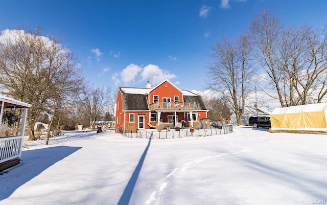 snow covered property featuring a balcony