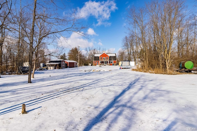 yard layered in snow with a trampoline and an outdoor structure