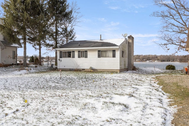 view of snow covered rear of property