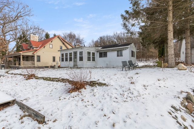 view of snow covered back of property