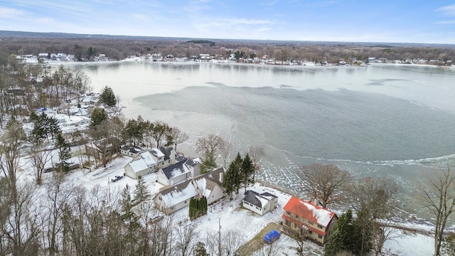 snowy aerial view featuring a water view