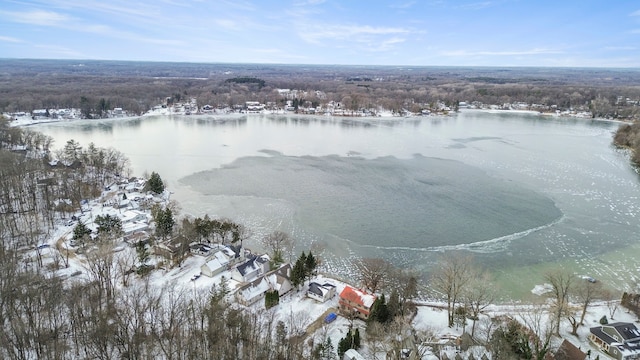 snowy aerial view with a water view