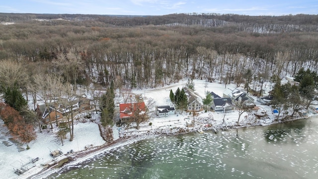 snowy aerial view featuring a water view