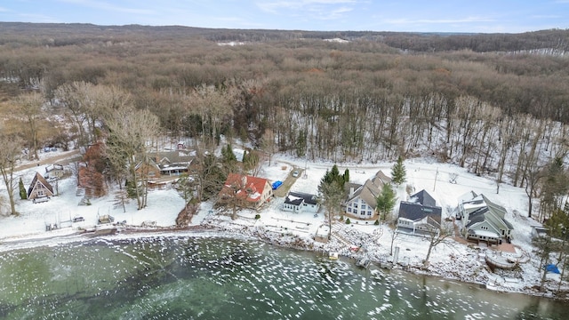 snowy aerial view featuring a water view