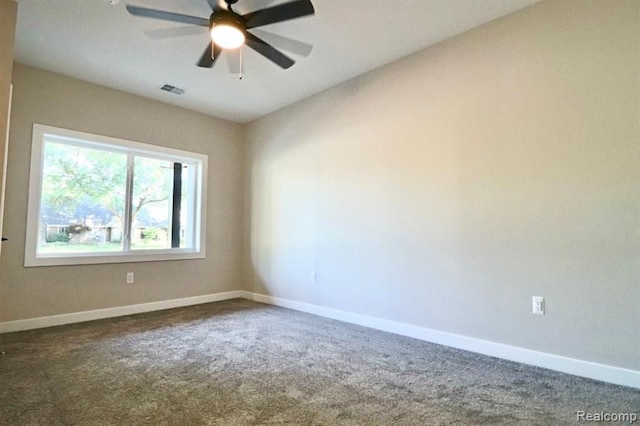 carpeted spare room featuring ceiling fan