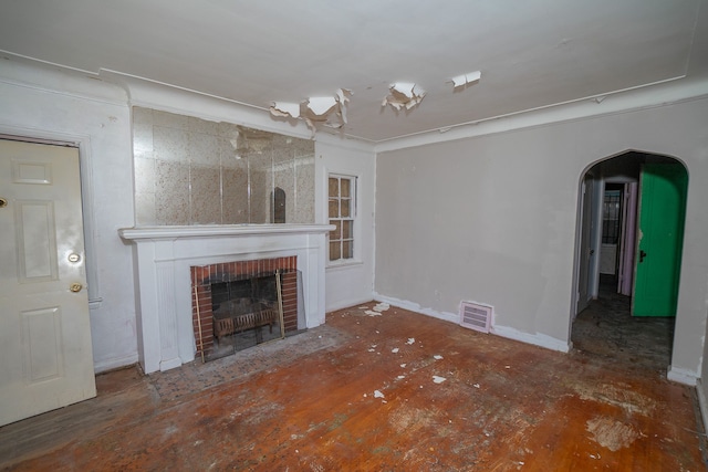 unfurnished living room with a fireplace and ornamental molding