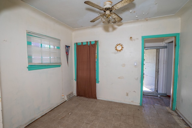 unfurnished room with a wealth of natural light and ceiling fan