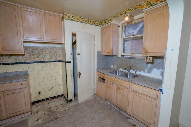 kitchen with backsplash, light brown cabinets, and sink