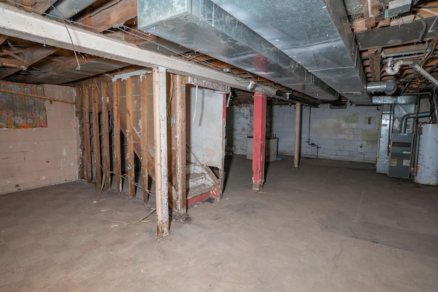 basement featuring heating unit and water heater