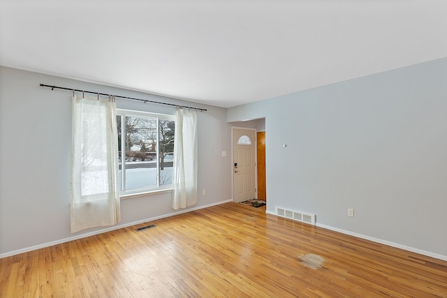 spare room with light hardwood / wood-style floors