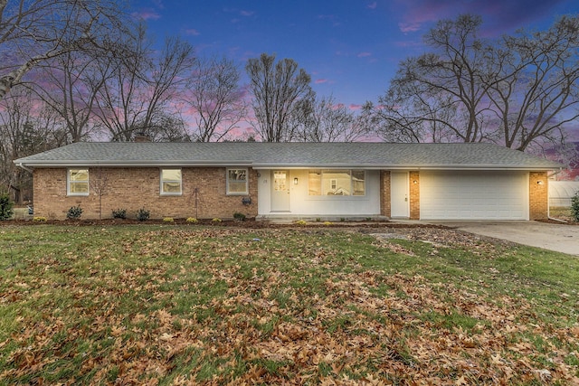 ranch-style home with a lawn and a garage