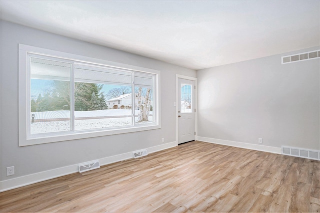 spare room with light hardwood / wood-style flooring