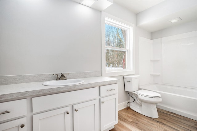 full bathroom with hardwood / wood-style flooring, vanity, toilet, and bathtub / shower combination