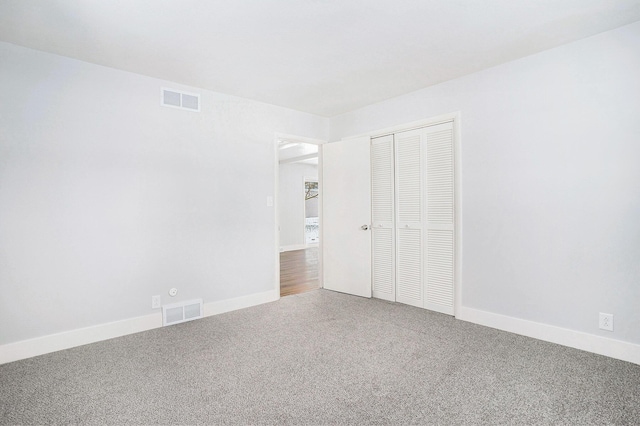 unfurnished bedroom featuring carpet floors and a closet