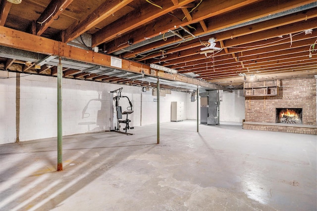 basement with heating unit and a brick fireplace