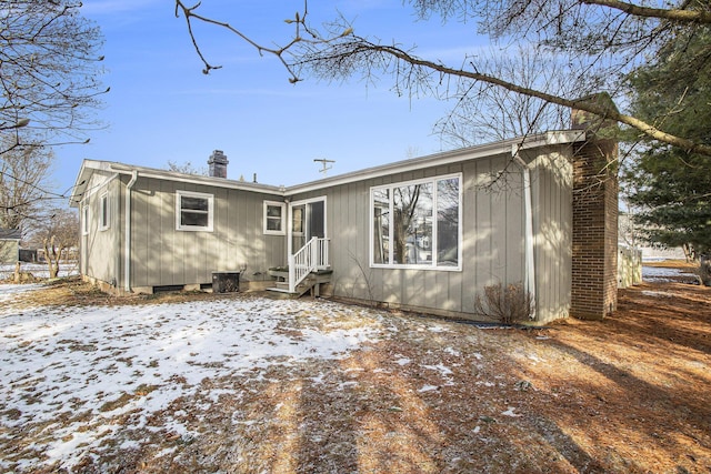 view of snow covered rear of property