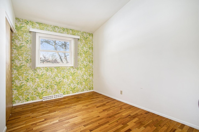 empty room with light hardwood / wood-style flooring