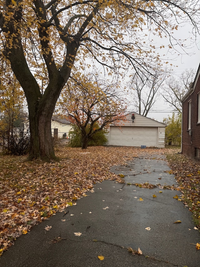 view of side of home featuring a garage and an outdoor structure