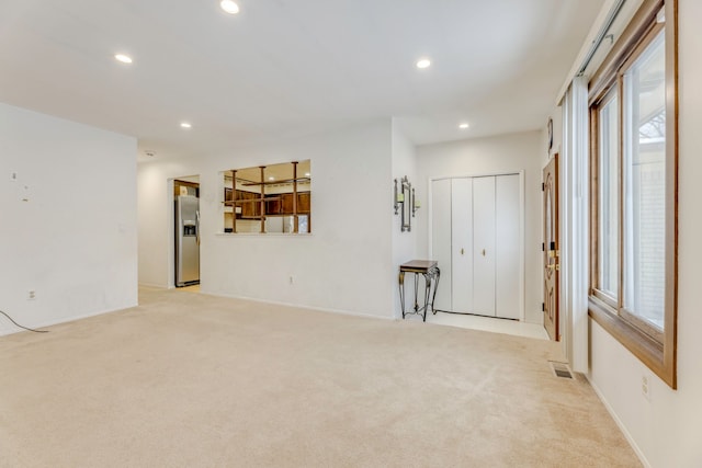 unfurnished room with light colored carpet